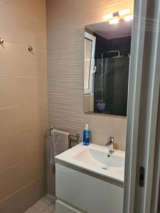 a bathroom with a sink and a mirror at Calle Cañón 9 in Cartagena +35 photos