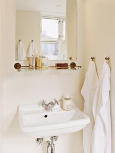 a bathroom with a sink and a mirror at Coco Hotel in Copenhagen +34 photos