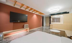 a hotel room with a bed and a flat screen tv at BrownDot Hotel Bong-Duk in Daegu