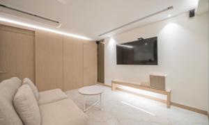 a living room with a couch and a tv on a wall at BrownDot Hotel Bong-Duk in Daegu +12 photos