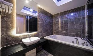 a bathroom with a sink and a bath tub at BrownDot Hotel Bong-Duk in Daegu