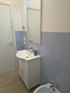 a bathroom with a sink and a mirror and a toilet at NonSoloCitta' in Torrette +5 photos