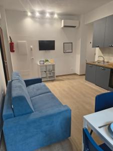 a living room with a blue couch and a kitchen at NonSoloCitta' in Torrette