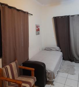 a small bedroom with a bed and a chair at Real Apartment Αληθινή Διαμονή in Diakopto