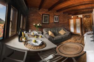 a living room with a table and a couch at El Mirador in Cudillero