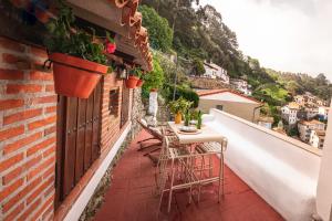 a balcony with a table and chairs on a building at El Mirador in Cudillero