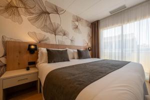 a bedroom with a large bed and a window at Neptuno Aparthotel in Calella +30 photos