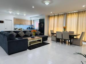a living room with a couch and a table at Feels Like Home in Wyndham Vale