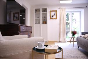 a living room with a couch and a coffee table at Ferienwohnung Oswald mit Garten im EG in Kochel