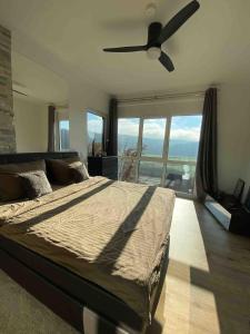 a bedroom with a bed and a ceiling fan at Spa-Villa mit privatem Whirlpool&Sauna und Panoramablick in Wellheim