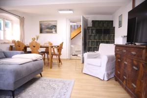 a living room with a couch and a dining room at Ferienwohnung Oswald mit Garten im EG in Kochel +26 photos