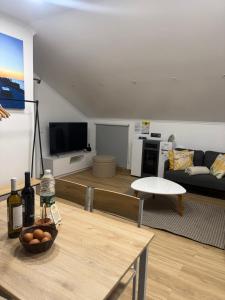 a living room with a couch and a table at Palheiro dos 3 A`s in Achadas da Cruz