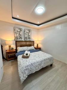 a bedroom with a bed and two night stands and two lamps at Villa El Marie in Bacnotan