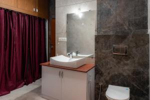 a bathroom with a sink and a toilet at Prana pulse villa stay gokulam in Mysore +24 photos