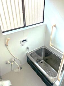a small bathroom with a sink in a room at The Village House 1 in Hadano