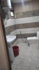 a bathroom with a sink and a toilet at Rupli homestay in Joshīmath