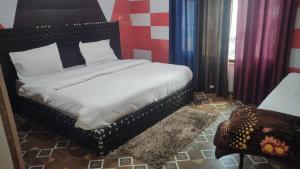 a bedroom with a bed and a chair at Rupli homestay in Joshīmath +5 photos