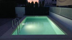 a swimming pool at night with the lights on at Casa Gonia in Riumar +13 photos