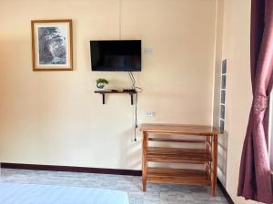 a bedroom with a flat screen tv on the wall at Rimlay Bay View in Ko Yao Noi