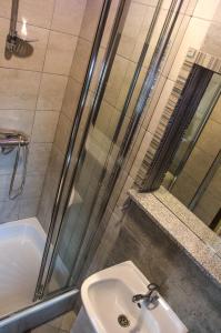 a bathroom with a shower and a sink and a tub at Pokoje Gościnne Anna in Poronin +20 photos