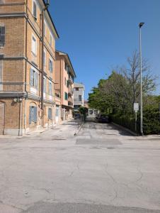 an empty street in front of a brick building at NonSoloCitta' in Torrette