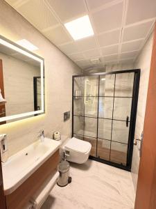 a bathroom with a toilet and a sink and a shower at Volonte Hotel & Spa in Bahçelievler +31 photos