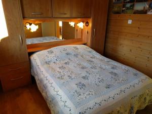 a small bedroom with a bed and a mirror at Chalet Daria in Prémanon