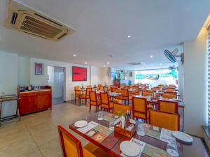 a large dining room with tables and chairs at Trevon Hotels & Resorts Candolim Goa in Candolim