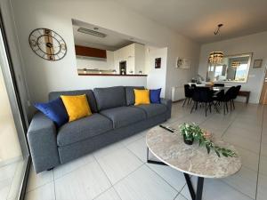 a living room with a couch and a table at Queens Boutique Apartment 2BR in Ayios Dhometios