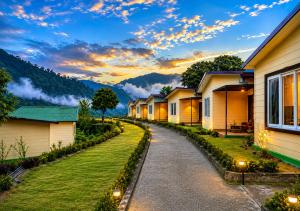 a row of houses on a street at sunset at HR The nature resort in Birbhaddar