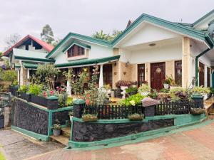a house with potted plants in front of it at Little England Grand Hotel in Nuwara Eliya +13 photos