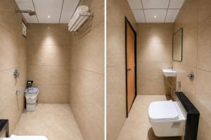 a bathroom with a toilet and a sink at Hotel Rushikesh inn Dwarka in Dwarka