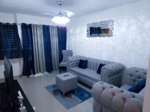 a living room with a couch and a tv at Charming home in Cancino