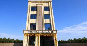 a tall building with a sign in front of it at Hotel Rushikesh inn Dwarka in Dwarka