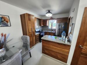 a kitchen with wooden cabinets and a counter top at Charming home in Cancino