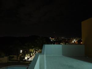 a view of the city at night from a building at Charming home in Cancino