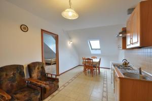 a kitchen with a couch and a sink and a table at Agroturystyka Nad Hańcza - apartament in Błaskowizna +25 photos