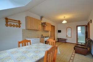 a kitchen and dining room with a table and chairs at Agroturystyka Nad Hańcza - apartament in Błaskowizna