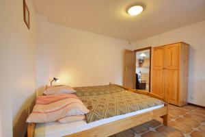 a bedroom with a bed with pillows on it at Agroturystyka Nad Hańcza - apartament in Błaskowizna