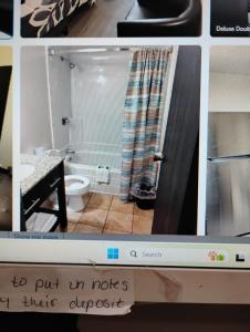 a television screen with a picture of a bathroom at The suite in Rapid City