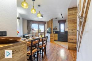 a kitchen and dining room with a table and chairs at Hostdomus - Clotes Dream Suite in Sauze d'Oulx +32 photos