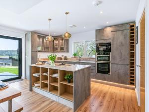 a kitchen with a large island in the middle at Brynor Lodge in Great Torrington
