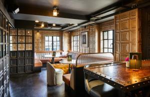 a restaurant with benches and tables in a room at The Rex - formerly Hotel Gotham in Manchester +43 photos