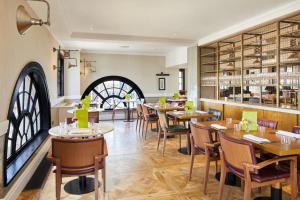 a restaurant with tables and chairs and a bar at The Rex - formerly Hotel Gotham in Manchester