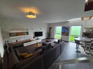 a large living room with a couch and a table at Weinbleibe Weingut Beyer in Dorndorf +10 photos