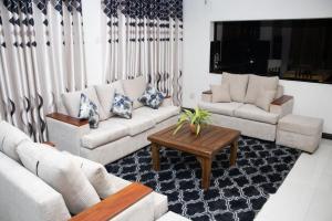 a living room with two couches and a coffee table at Nature Park villa in Arambegama +13 photos