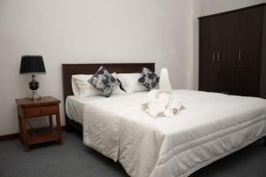 a bedroom with a bed with a stuffed animal on it at Nature Park villa in Arambegama