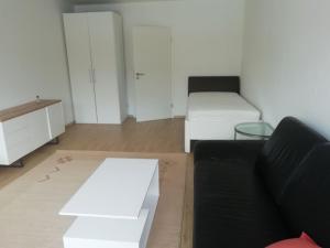 a living room with a black couch and a table at lichtdurchflutete 2 Zimmer Wohnung in Dinslaken