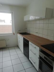 a white kitchen with a sink and a window at lichtdurchflutete 2 Zimmer Wohnung in Dinslaken