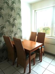 a dining room table with chairs and a window at lichtdurchflutete 2 Zimmer Wohnung in Dinslaken